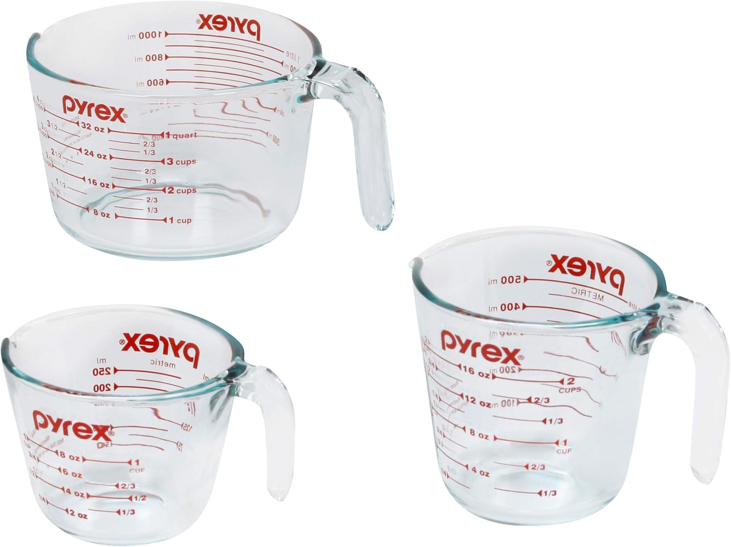 Pyrex three piece glass measuring cup set in one cup, two cup, and four cup sizes with red printed measurement markings