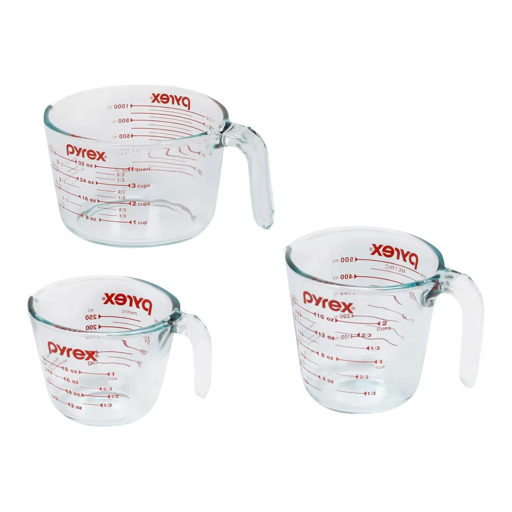 Pyrex three piece glass measuring cup set in one cup, two cup, and four cup sizes with red printed measurement markings
